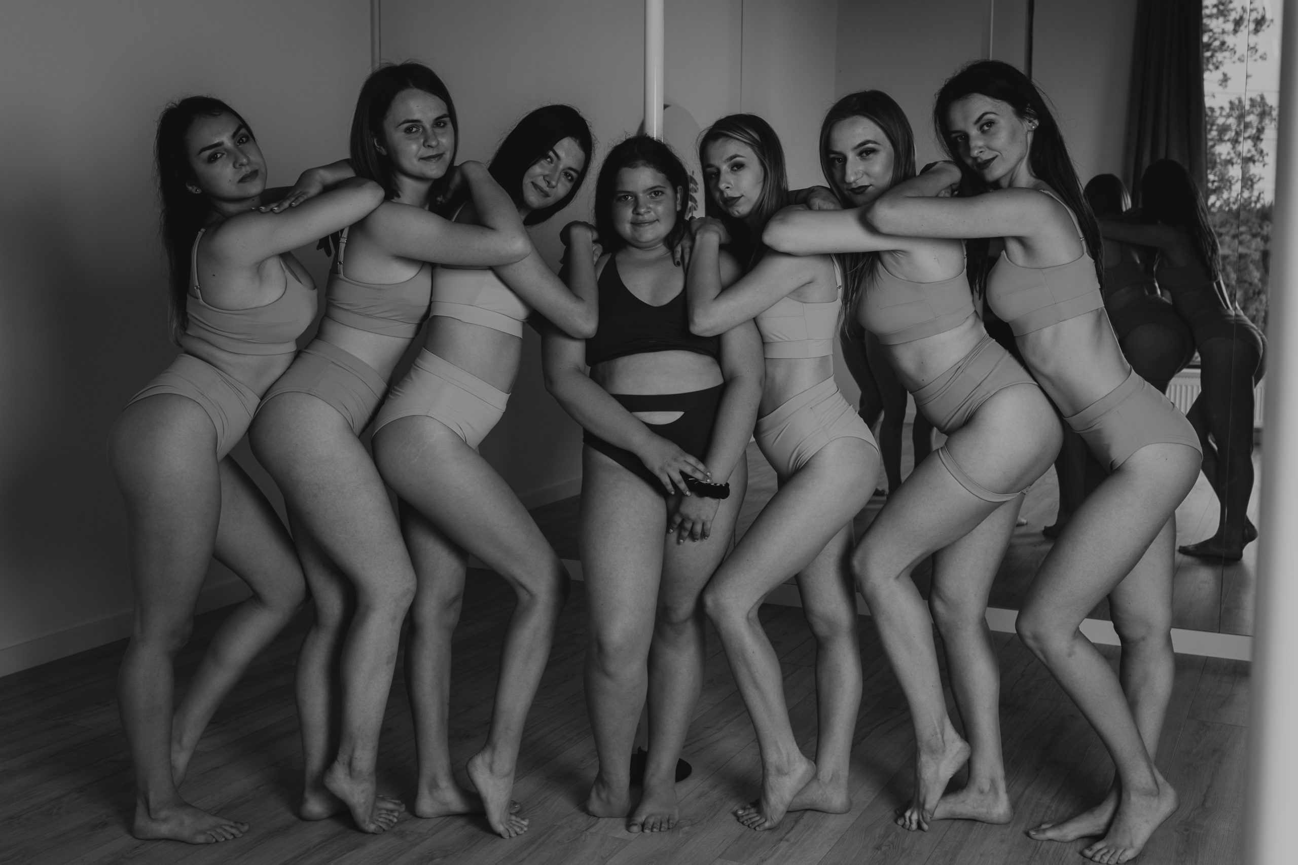 Fotografia taneczna grupa siedmiu uśmiechniętych dziewczyn po treningu pole dance