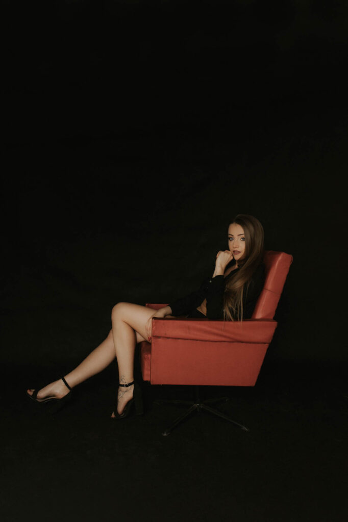 dziewczyna siedzi w czerwonym fotelu